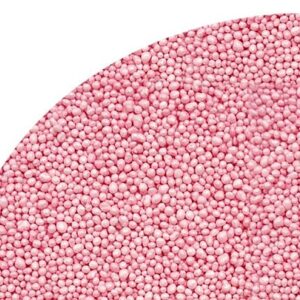 Close-up of pink round craft beads tightly packed on a curved surface.