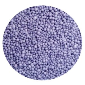 Close-up of tiny purple sugar pearls covering a surface as a candy sprinkles texture