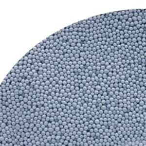 Close-up of numerous small blue-gray spherical pellets densely packed along a curved edge, like a granulated material. read more? (informative)