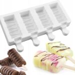 White four-cavity silicone ice pop mold with frozen pops and chocolate-draped treats on sticks.