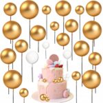 99520aaac82d38cbb4aa86cb74c08835jpg › Udanewypieki Gold balloon cluster on sticks with a pink celebration cake and sweets at the bottom, festive party backdrop