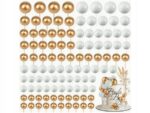 a1013e48f5c6a3d9502709aeb593137d-2jpg › Udanewypieki Gold and white pearl balloon garland backdrop with a small wedding cake on the right side.