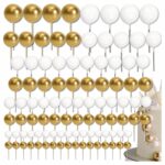 a4fe9cfb894a928bb62d144cc7864ee5-2jpg › Udanewypieki Rows of gold and white balloons on sticks arranged in a repeating pattern as a party backdrop.